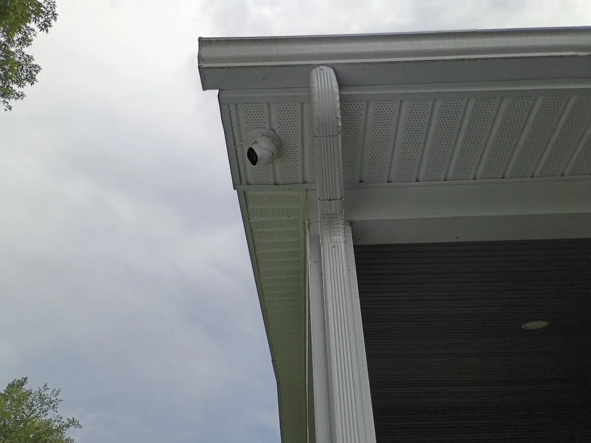 Reolink dome security camera mounted under a porch soffit